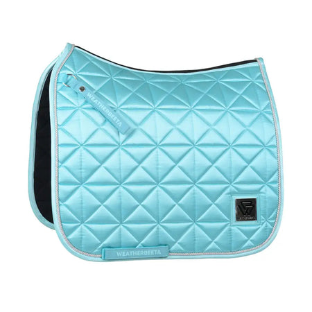 Light blue quilted saddle pad with 'WeatherBeeta' branding on a white background