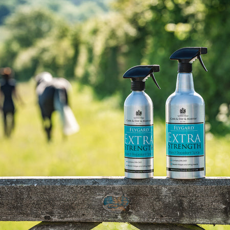 Two bottles of 'Extra Strength' product on a wooden bench with a blurred natural background
