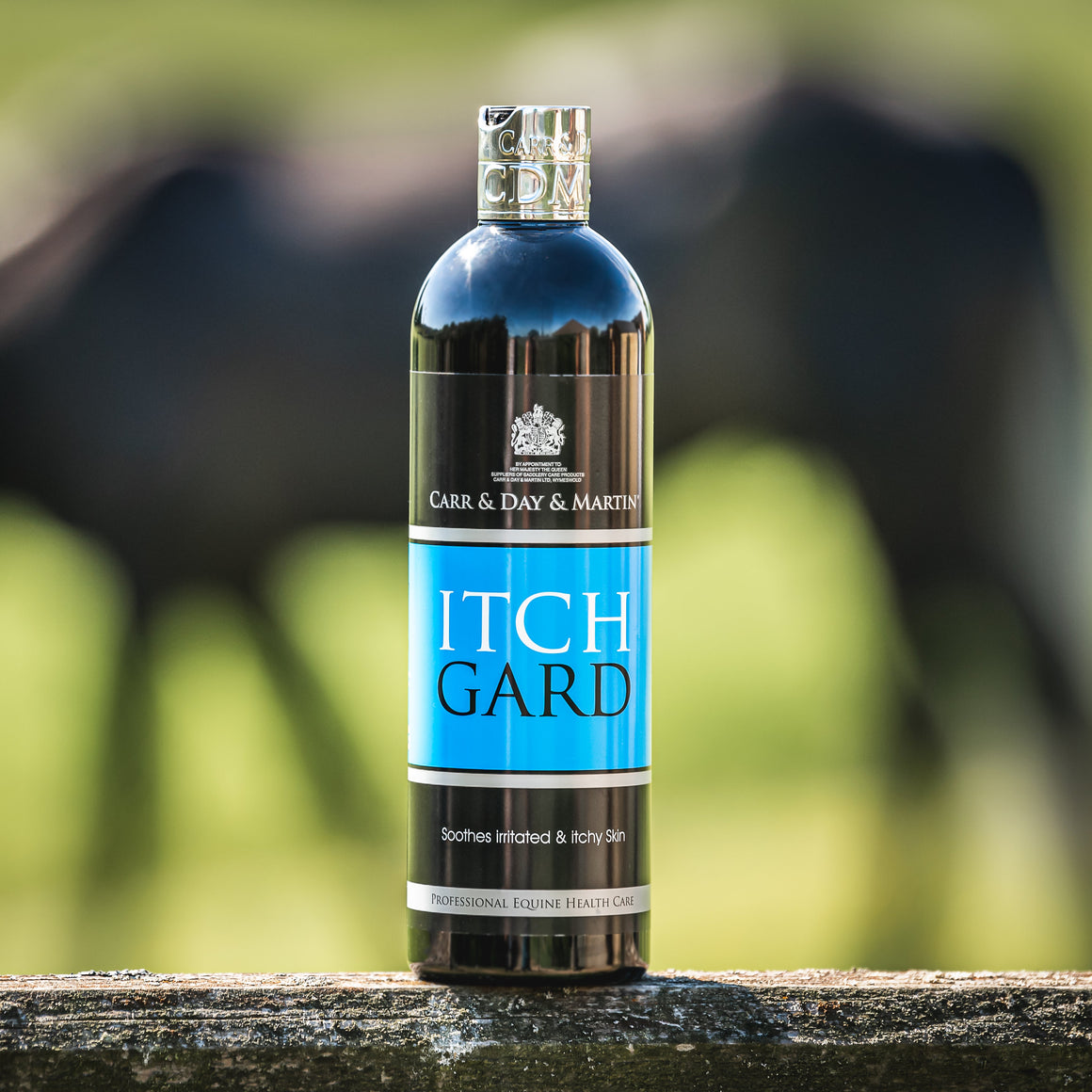 Bottle of Itch Gard with a horse in the background