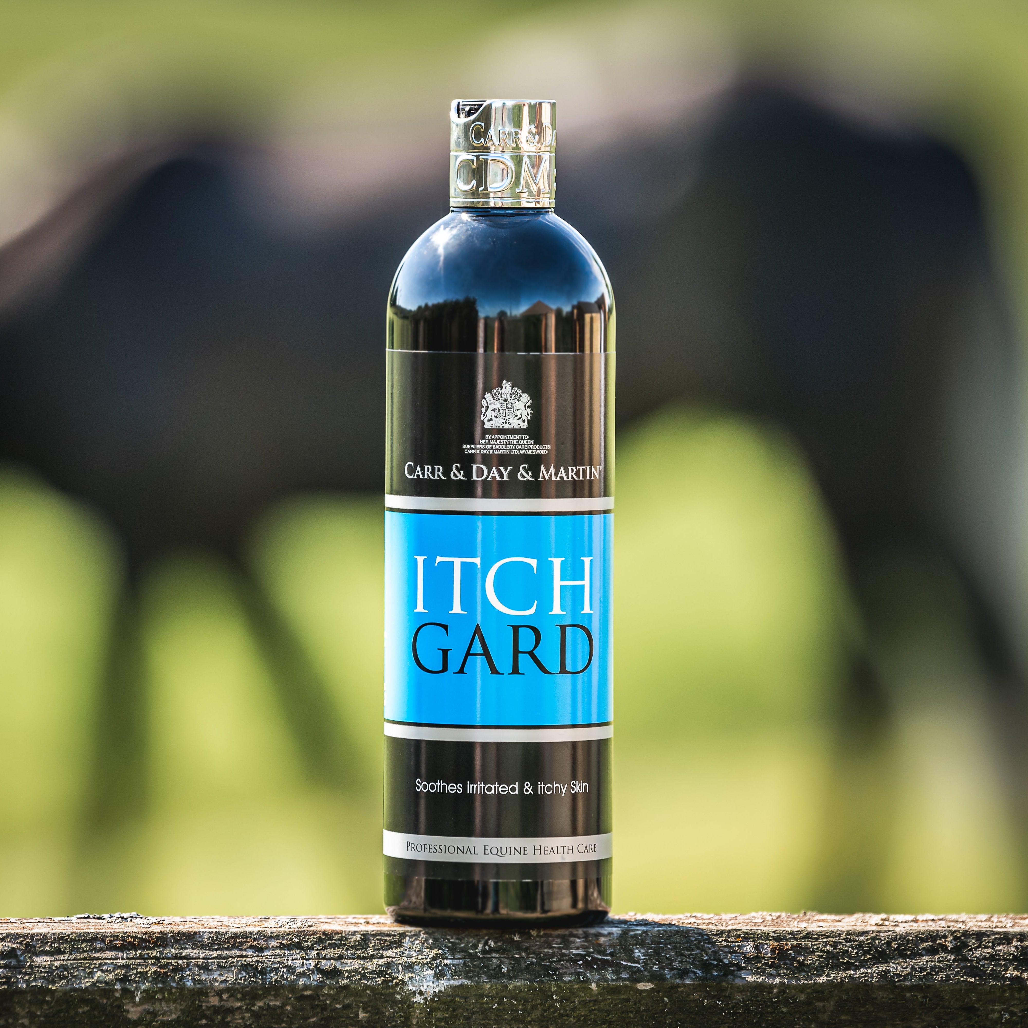 Bottle of Itch Gard with a horse in the background