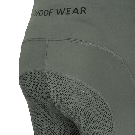 Green leggings with 'WOOF WEAR' branding on a white background